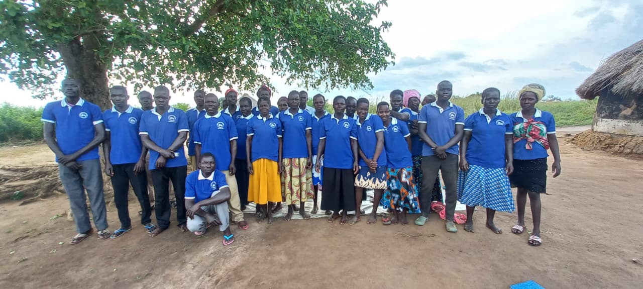 Community gathering with children in red uniforms